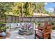 Beautiful backyard featuring an inviting fire pit, comfortable seating, and lush greenery at 125 E Miller St, Orlando, FL 32806