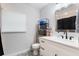Bright bathroom featuring a white vanity with a quartz countertop and decorative tile flooring at 125 E Miller St, Orlando, FL 32806