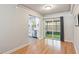 Bright dining room with wood flooring, white trim, and sliding door access to screened patio at 125 E Miller St, Orlando, FL 32806