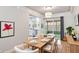 Bright dining area featuring modern lighting and direct access to a sunroom and kitchen at 125 E Miller St, Orlando, FL 32806