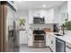 Modern kitchen with stainless steel appliances and white cabinets, ready for cooking at 125 E Miller St, Orlando, FL 32806