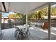Outdoor patio with a dining set, fire pit, and views of the backyard landscaping at 125 E Miller St, Orlando, FL 32806