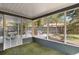 Bright sunroom with outdoor seating area and views of the backyard at 125 E Miller St, Orlando, FL 32806