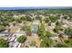 An aerial view of a single-Gathering home surrounded by lush greenery and a glimpse of the nearby bay at 131 Autumn Ct, St Cloud, FL 34771
