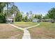 Large backyard featuring a gazebo, shed and beautiful green grass at 131 Autumn Ct, St Cloud, FL 34771