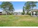 Grassy backyard featuring a well-maintained lawn, gazebo, shed, and home at 131 Autumn Ct, St Cloud, FL 34771