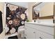 Bathroom with floral shower curtain, bronze mirror, and black floor mat at 131 Autumn Ct, St Cloud, FL 34771