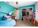 Bright bedroom featuring blue walls, closet, desk and large comfortable bed at 131 Autumn Ct, St Cloud, FL 34771