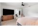 Neutral bedroom featuring a dresser, television, and walk-in closet at 131 Autumn Ct, St Cloud, FL 34771