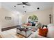 A comfortable living room space with tile flooring, an arched window, and a neutral color palette for a relaxing atmosphere at 131 Autumn Ct, St Cloud, FL 34771