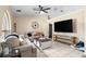A cozy living room is furnished with comfortable seating, stylish decor, and a modern ceiling fan at 131 Autumn Ct, St Cloud, FL 34771