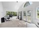 Bright sunroom with a high vaulted ceiling, ample light and a modern desk at 131 Autumn Ct, St Cloud, FL 34771