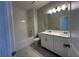 Bright bathroom featuring a tub, shower, and double sink vanity with gray walls and light wood-look flooring at 1360 Twelve Oaks Rd, St Cloud, FL 34771