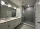 Modern bathroom with double sinks, vanity, and glass shower enclosure with tile surround at 1360 Twelve Oaks Rd, St Cloud, FL 34771