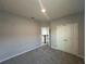 Carpeted bedroom with view of stairs, featuring a double door closet at 1360 Twelve Oaks Rd, St Cloud, FL 34771