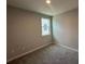 A carpeted bedroom with natural light coming in through the window at 1360 Twelve Oaks Rd, St Cloud, FL 34771
