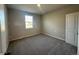 Cozy bedroom with neutral walls, carpet flooring, and a window providing natural light at 1360 Twelve Oaks Rd, St Cloud, FL 34771