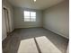 A well-lit bedroom with gray carpet, a bright window, and neutral walls, offering a calm and inviting space at 1360 Twelve Oaks Rd, St Cloud, FL 34771