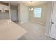 Dining area with white trim, a modern chandelier, and bright natural light from the window at 1360 Twelve Oaks Rd, St Cloud, FL 34771