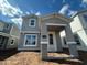 Charming two-story home featuring a covered porch with stylish gray paint and white trim at 1360 Twelve Oaks Rd, St Cloud, FL 34771