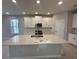 Bright kitchen featuring white cabinets, stainless steel appliances, and a large center island at 1360 Twelve Oaks Rd, St Cloud, FL 34771