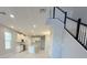 Modern kitchen with white cabinets, stainless steel appliances, and an island overlooking the living area at 1360 Twelve Oaks Rd, St Cloud, FL 34771