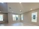Sun-filled living room with multiple windows and light-colored flooring, creating a bright and airy space at 1360 Twelve Oaks Rd, St Cloud, FL 34771