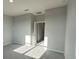 Bedroom with carpet, light-colored walls, and doorways to the bathroom and closet areas at 1360 Twelve Oaks Rd, St Cloud, FL 34771