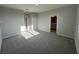 Spacious main bedroom with gray carpet, light walls, and access to the ensuite bathroom at 1360 Twelve Oaks Rd, St Cloud, FL 34771