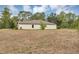 Scenic view of the backyard displaying a well-maintained lawn and the home's exterior at 14066 Sw 60Th Ter, Ocala, FL 34473