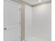 Bright bathroom featuring a clean white tiled shower and a simple, minimalist design at 14066 Sw 60Th Ter, Ocala, FL 34473