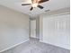 This carpeted bedroom includes closet space, a ceiling fan, and neutral walls at 14066 Sw 60Th Ter, Ocala, FL 34473