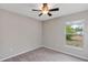 Bedroom with neutral walls, carpet flooring, and a window with backyard view at 14066 Sw 60Th Ter, Ocala, FL 34473