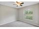 Bedroom with neutral walls, carpet flooring, and a window with blinds at 14066 Sw 60Th Ter, Ocala, FL 34473