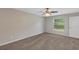Carpeted bedroom features a ceiling fan, natural light, and a closet at 14066 Sw 60Th Ter, Ocala, FL 34473