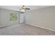 This carpeted bedroom features a ceiling fan, natural light, and a closet at 14066 Sw 60Th Ter, Ocala, FL 34473