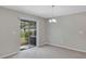 Carpeted dining room featuring a glass sliding door to the backyard at 14066 Sw 60Th Ter, Ocala, FL 34473