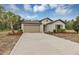 Well-maintained single-Gathering home featuring a spacious driveway, tidy landscaping, and an attached two-car garage at 14066 Sw 60Th Ter, Ocala, FL 34473