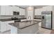 Bright kitchen featuring granite countertops, stainless steel appliances, and ample storage in white cabinets at 14066 Sw 60Th Ter, Ocala, FL 34473