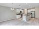Spacious open-concept kitchen with granite counters, stainless appliances, and seamless flow to carpeted living area at 14066 Sw 60Th Ter, Ocala, FL 34473