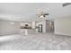 Open-concept living room and kitchen with stainless steel appliances and a ceiling fan at 14066 Sw 60Th Ter, Ocala, FL 34473