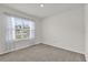 A bright bedroom filled with neutral paint and light-colored carpet at 149 Hickory Course Cir, Ocala, FL 34472