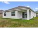 Exterior of home, showcasing a covered patio and a well-maintained lawn at 149 Hickory Course Cir, Ocala, FL 34472