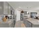 Spacious kitchen with gray cabinetry, stainless steel appliances, and granite countertops at 149 Hickory Course Cir, Ocala, FL 34472