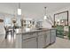 Open concept kitchen with large granite island, stainless steel appliances, pendant lighting at 149 Hickory Course Cir, Ocala, FL 34472