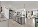 Kitchen with a large island, pendant lighting, and an open layout into dining and living areas at 149 Hickory Course Cir, Ocala, FL 34472