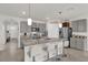 Kitchen featuring a large island with bar seating, granite countertops and stainless steel appliances at 149 Hickory Course Cir, Ocala, FL 34472