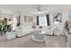 Bright living room features tile floors, a ceiling fan, neutral paint and abundant natural light at 149 Hickory Course Cir, Ocala, FL 34472