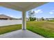 A covered patio with a view of the backyard and neighborhood beyond at 149 Hickory Course Cir, Ocala, FL 34472