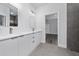 This modern bathroom features dual vanities and a glass-enclosed shower at 15296 Sw 56Th Terrace Rd, Ocala, FL 34473